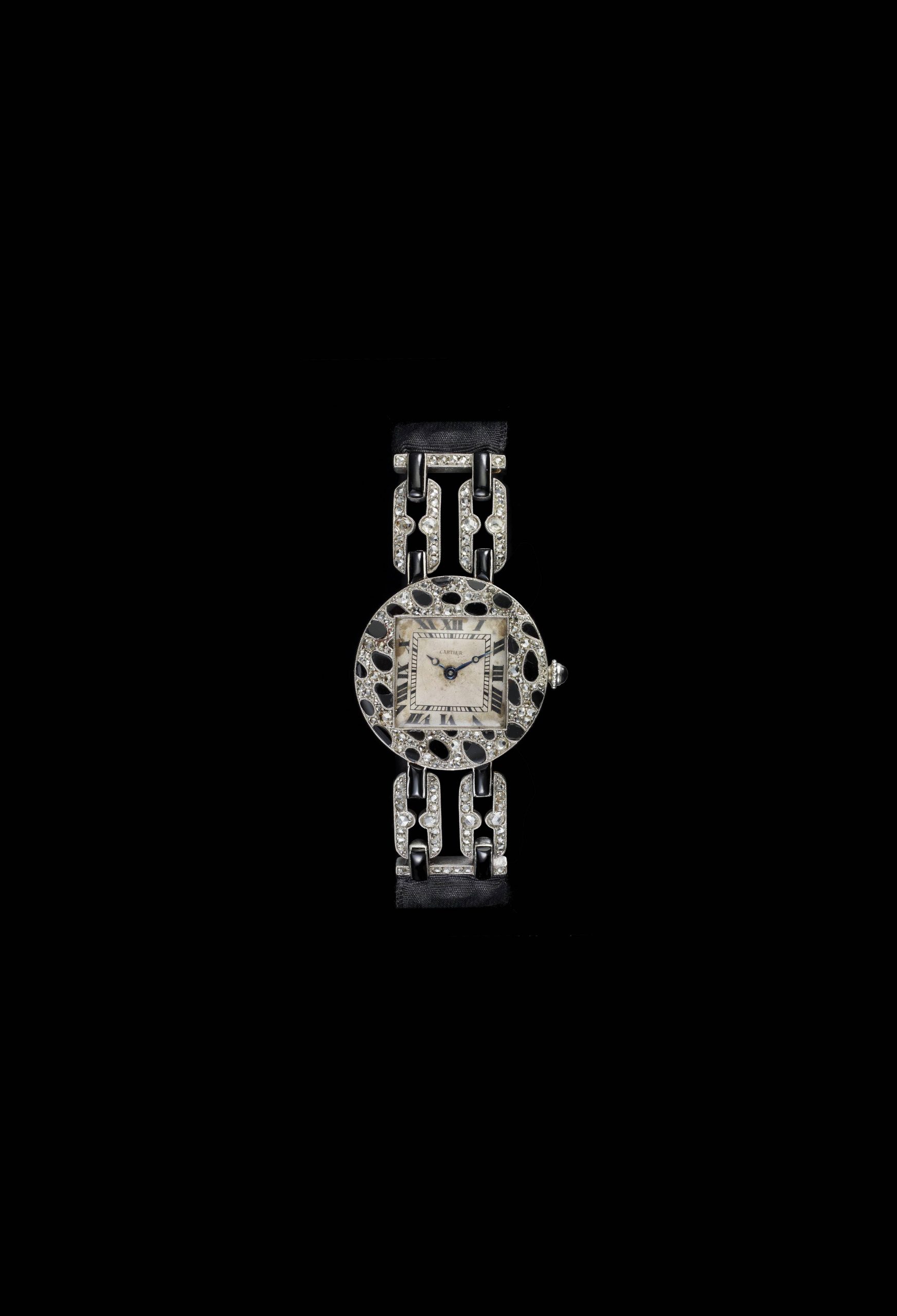Cartier's very first use of the panther motif, platinum, pink gold, rose-cut diamonds, onyx with moire strap.