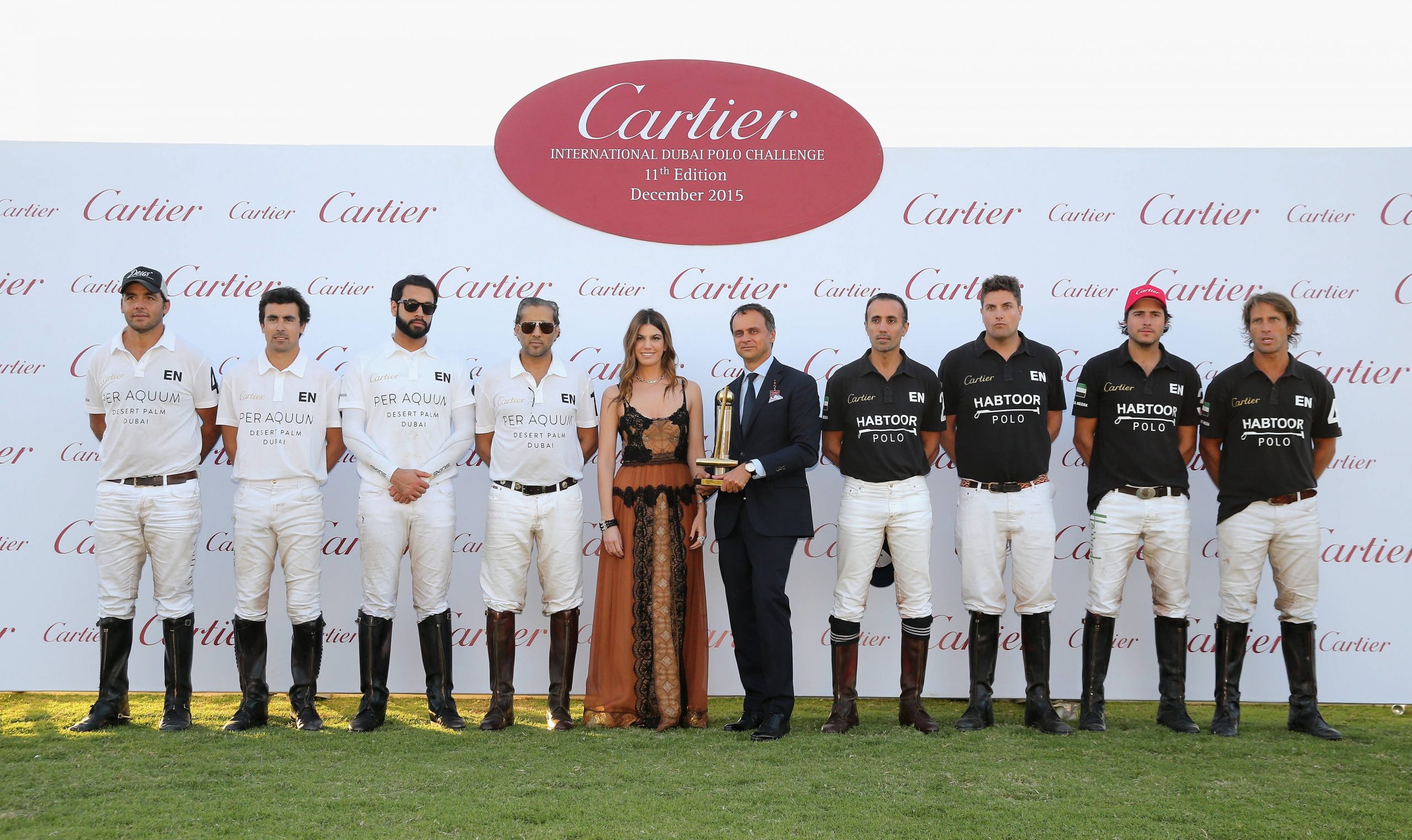 Bianca Brandolini and Regional Managing Director of Cartier Middle East, India and Africa Laurent Gabori pose with the Habtoor Polo and Desert Palm polo teams.